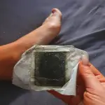 woman showing PureFeet patches after having used them